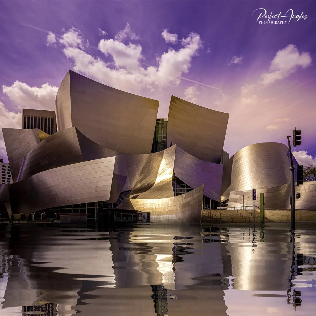 Walt Disney Concert Hall reflected in water at dusk